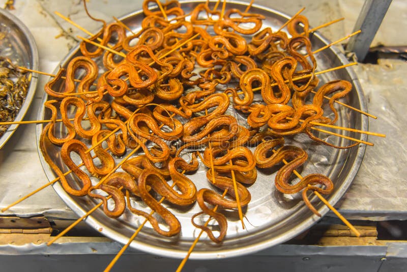 grilled snakes on sale for food market in China. Fish, meat.