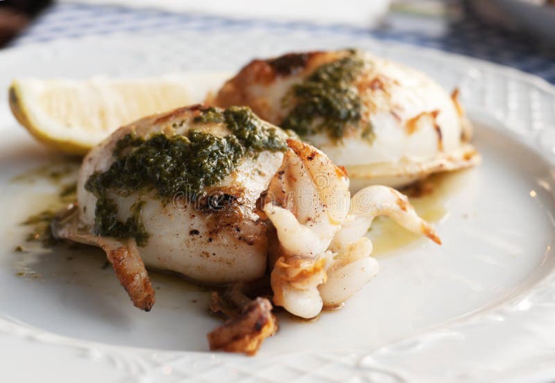 Grilled squid with special Canarian sauce mojo stock images