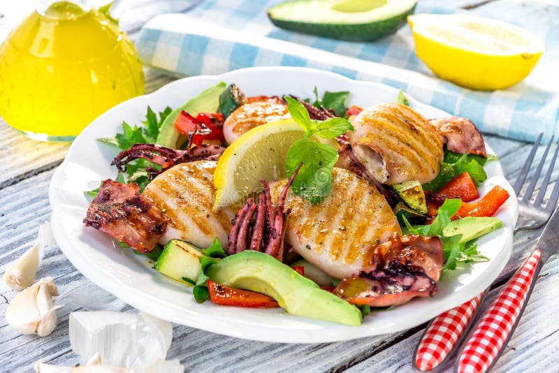 Grilled squids with vegetable stock image Grilled squids with vegetable stock image