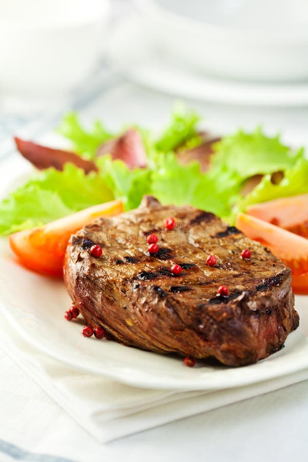 Grilled steak with pink pepper