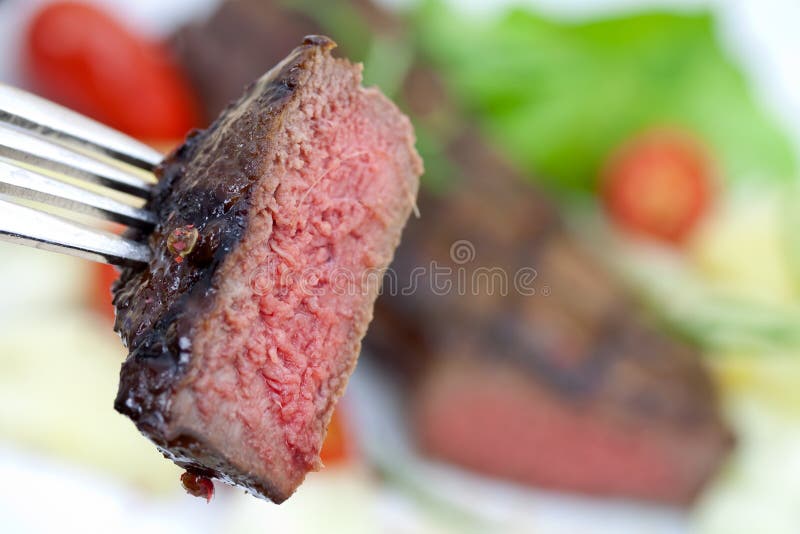 Grilled strip steak with tomato and salad