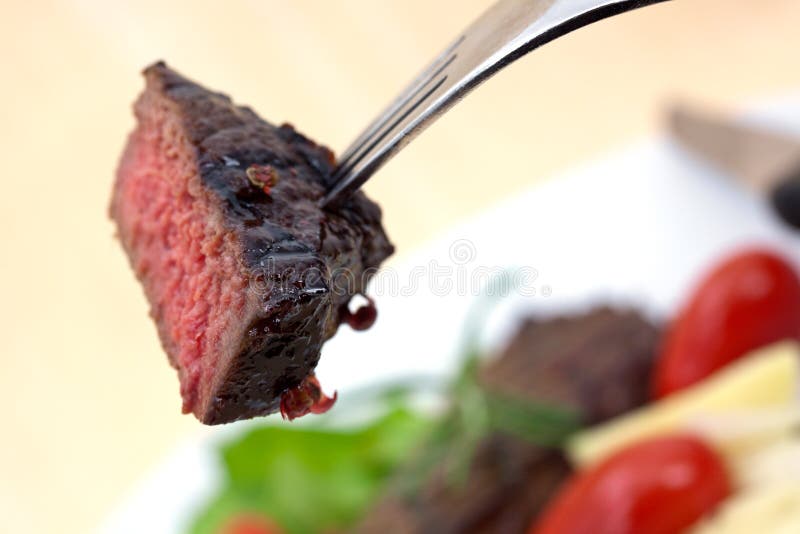 Grilled strip steak with tomato and salad