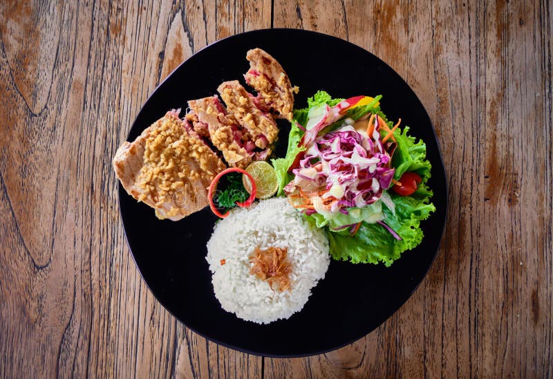 Grilled Tuna Steak with Rice and Vegetables on a Wooden Table. Top View