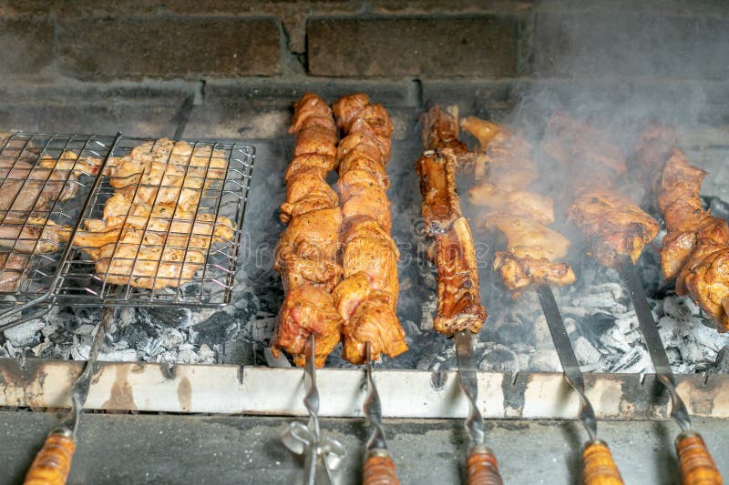 Grilling Marinated Shashlik On A Grill. Shashlik Is A Form Of Shish Kebab  Popular In Eastern, Central Europe And Other Places. Shashlyk (meaning  Skewered Meat) Was Originally Made Of Lamb. Stock Photo