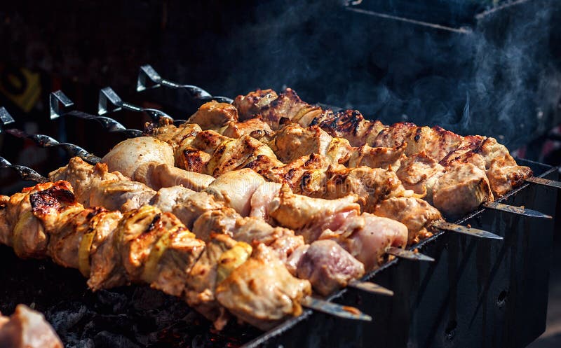 Grilling marinated shashlik on a grill. Shashlik is a form of Shish kebab  popular in Eastern, Central Europe and other places. Shashlyk meaning skewer  Stock Photo - Alamy