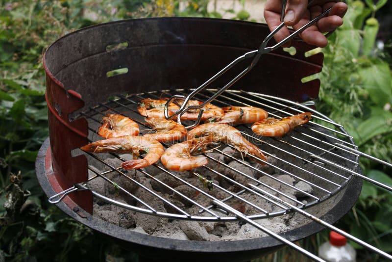 Grilling prawns on a barbecue