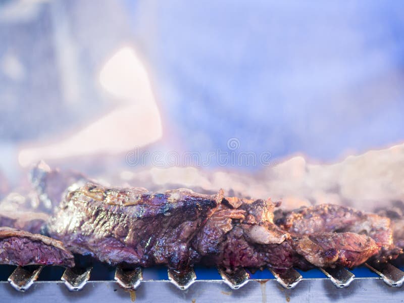 Grilling red meat and sausages at sunset outdoors gathering with royalty free stock photo Grilling red meat and sausages at sunset outdoors gathering with royalty free stock photo
