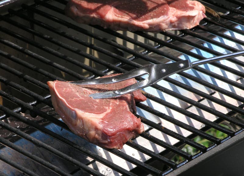 Grilling Steak stock photo. Image of fork, food, grilling 1043270
