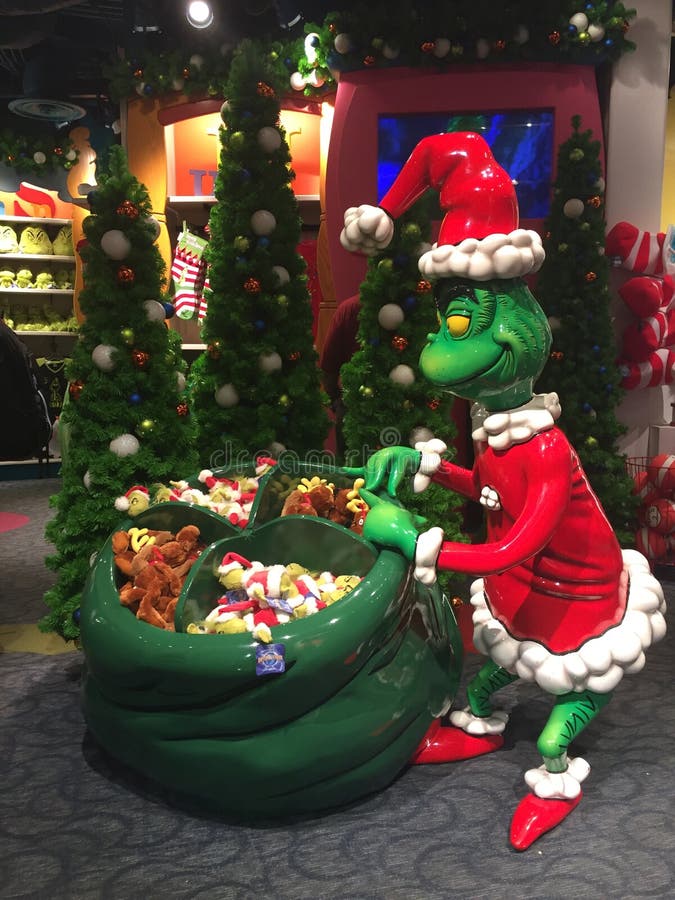 A Store display featured a life size Grinch Who Stole Christmas figure with a bag full of items customers can purchase. Figure is displayed inside one of the souvenir stores at Seuss World in Universal Studios Orlando, Florida. A Store display featured a life size Grinch Who Stole Christmas figure with a bag full of items customers can purchase. Figure is displayed inside one of the souvenir stores at Seuss World in Universal Studios Orlando, Florida.