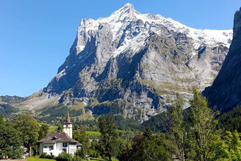 Huge rocky mountain and a small church