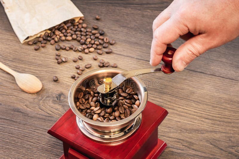 Grinding Coffee on an Old Handmade Coffee Grinder_ Stock Image Image