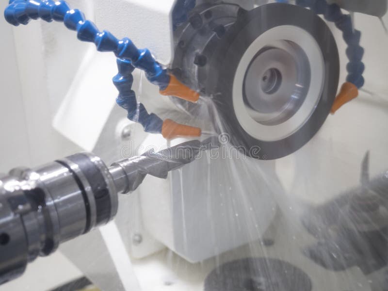 Grinding cutting tool by grinding machine stock image