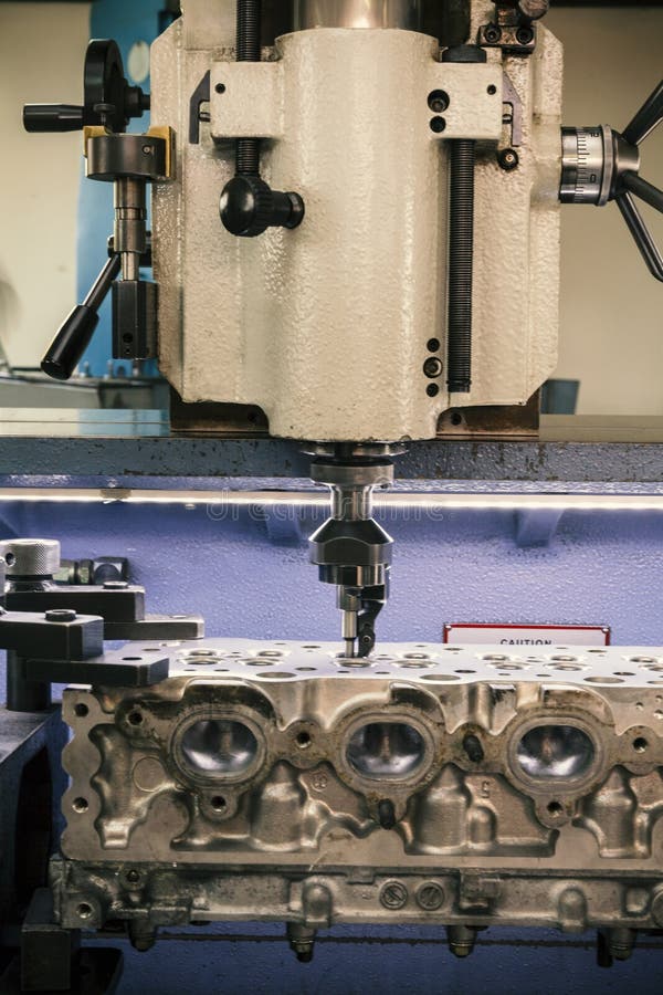 Grinding cylinder head stock image. Image of metallic 123632535