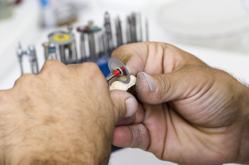 Grinding dentures stock photography