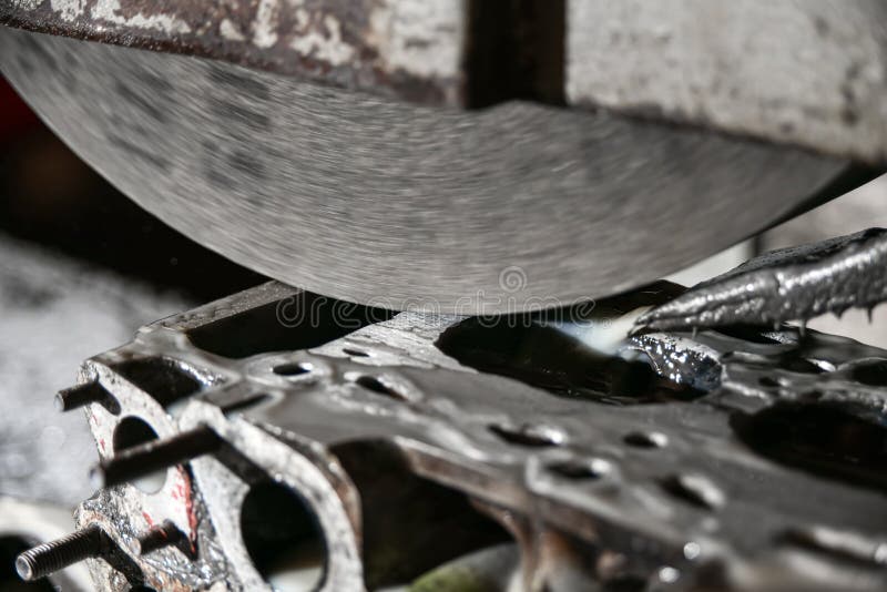 Grinding, finishing and alignment of the engine cylinder head with an abrasive stone on a surface grinder royalty free stock image