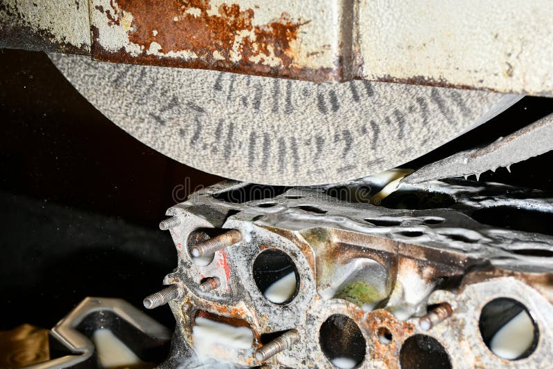 Grinding and finishing of the cylinder head of a car engine on a surface grinder royalty free stock photography