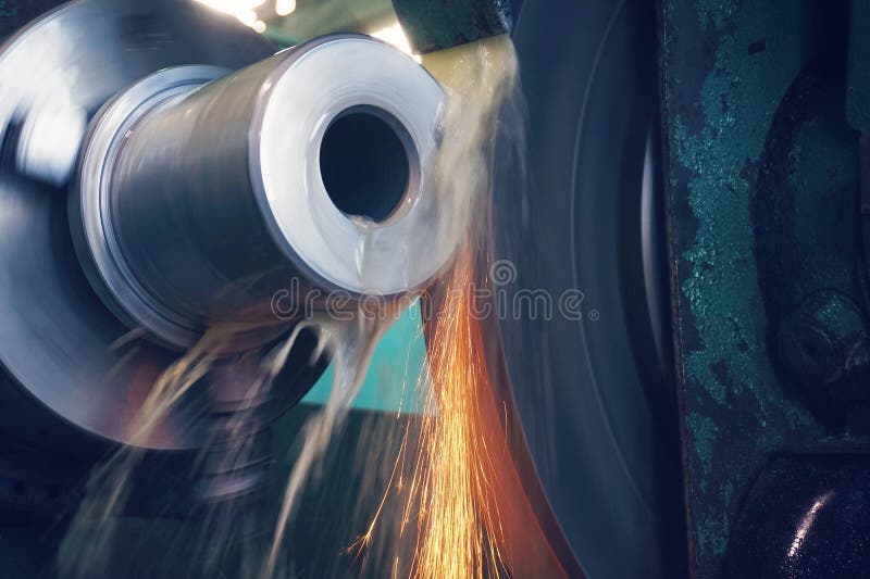 Grinding of metal, final processing of a part on a precision grinding machine with sparks and cooling. royalty free stock image