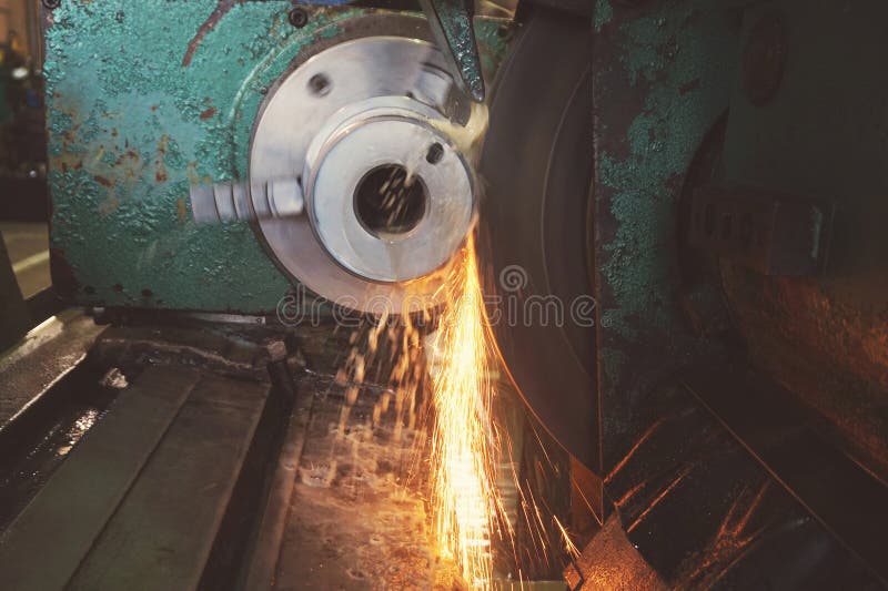 Grinding of metal, final processing of a part on a precision grinding machine with sparks and cooling. royalty free stock photos