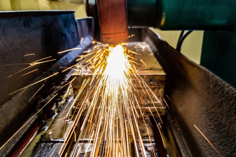 Grinding Metal on a Machine, Sparks Fly into the Chamber. Front View