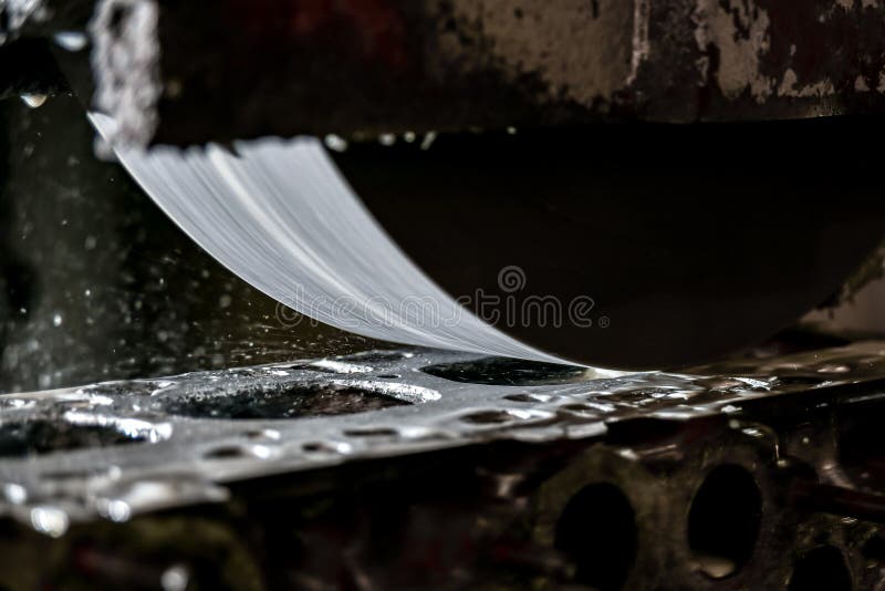 Grinding the Surface of the Cylinder Head on a Surface Grinder Stock