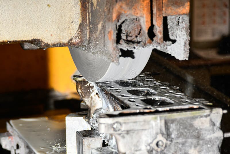 Grinding the surface of the cylinder head on a surface grinder stock images