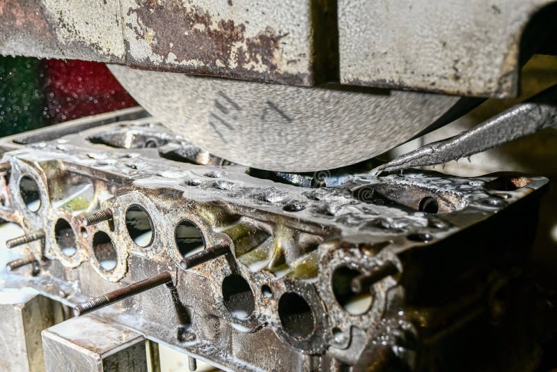 Grinding the Surface of the Cylinder Head on a Surface Grinder Stock