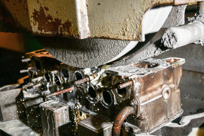 Grinding the surface of the cylinder head on a surface grinder royalty free stock image