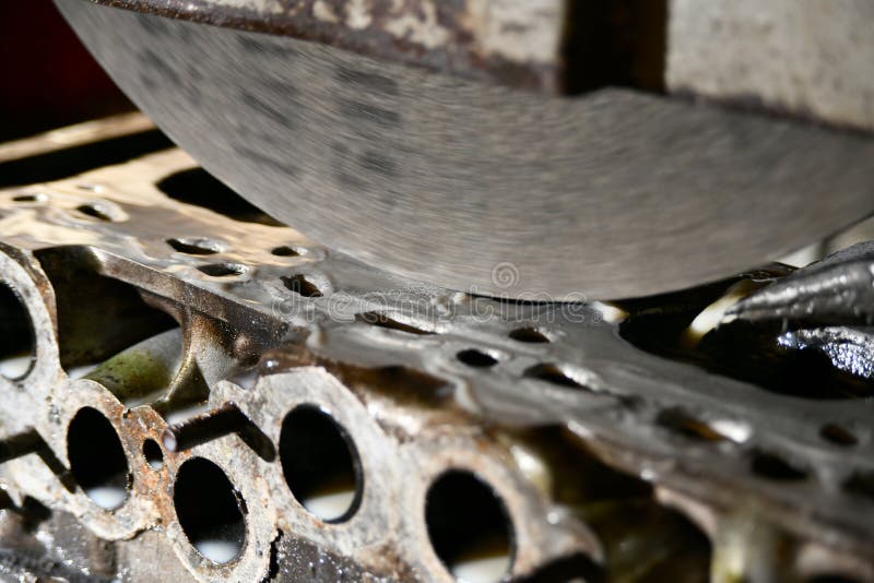 Grinding the Surface of the Cylinder Head on a Surface Grinder Stock