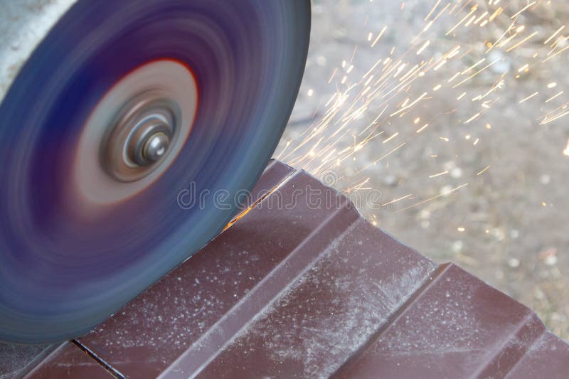 A grinding wheel is spinning and creating sparks stock photography