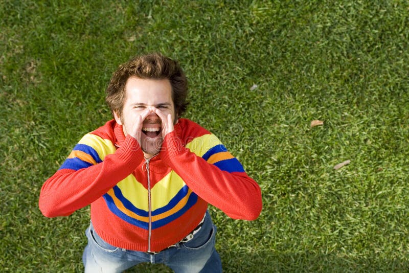 A high view perspective of a young man screaming ans shouting out loud. A high view perspective of a young man screaming ans shouting out loud