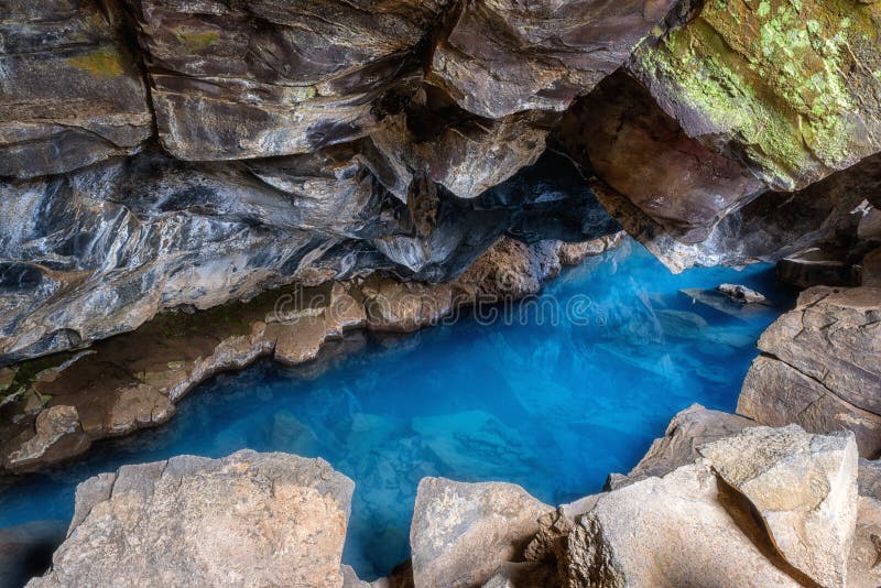 Grjotagja cave in Iceland with thermal spring hot amazing blue water, small lava cave