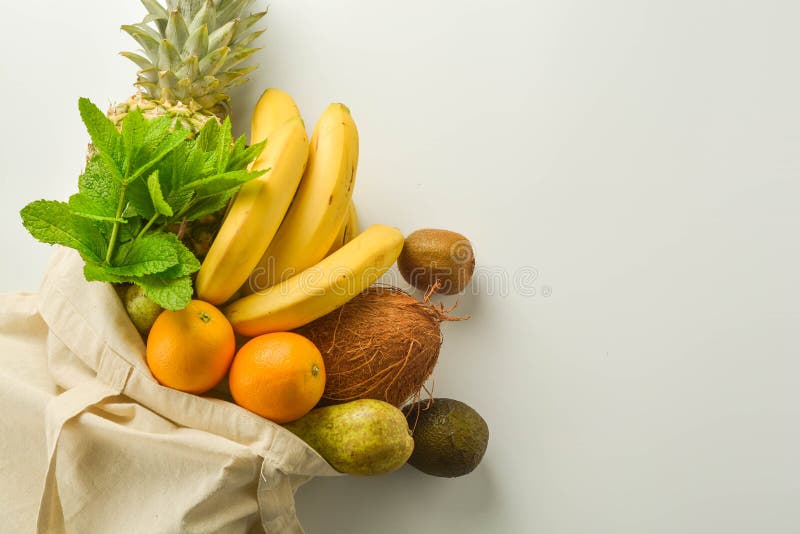 Grocery shopping with eco bag over white background. Zero waste and plastic free concept. Flat lay, top view. Copy space