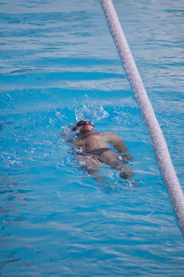 GRODNO, BELARUS - DEC 17: Man Swims in Public Swimming Pool in Grodno ...