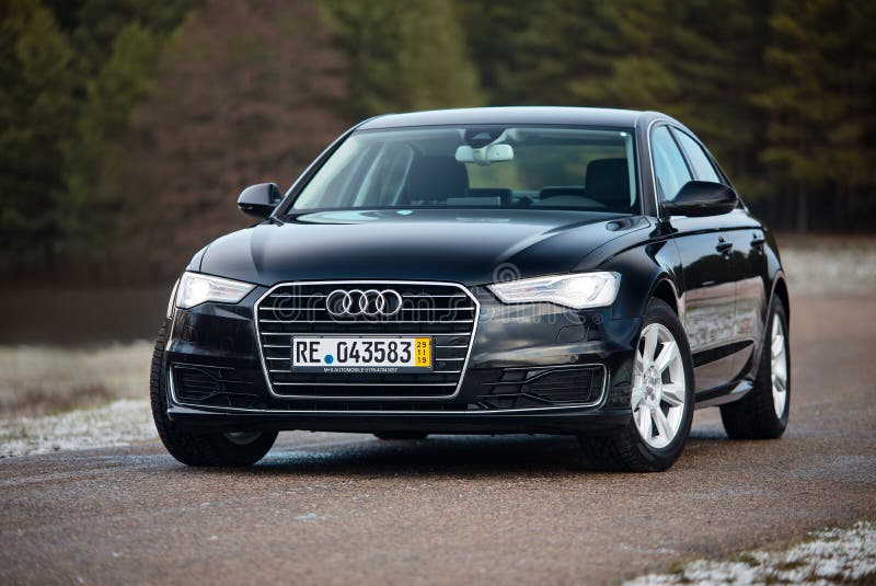 GRODNO, BELARUS - DECEMBER 2019: Audi A6 4G, C7 2.0 TDI 190 Hp 2016 outdoors on winter road during testdrive with forest on background. GRODNO, BELARUS - DECEMBER 2019: Audi A6 4G, C7 2.0 TDI 190 Hp 2016 outdoors on winter road during testdrive with forest on background