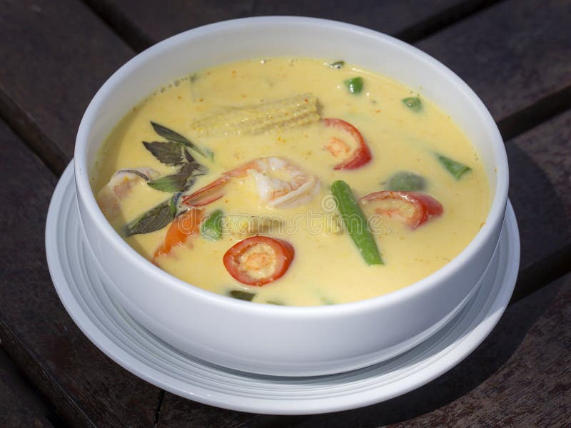 Groene kerrie romige soep met kokosmelk, garnalen, Spaanse peper, boon in witte kom, Thaise keuken stock fotografie Groene kerrie romige soep met kokosmelk, garnalen, Spaanse peper, boon in witte kom, Thaise keuken stock fotografie