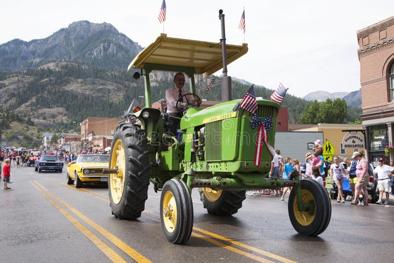 Groene tractoraandrijving in 4 Juli de Parade van de Onafhankelijkheidsdag royalty-vrije stock afbeeldingen Groene tractoraandrijving in 4 Juli de Parade van de Onafhankelijkheidsdag royalty-vrije stock afbeeldingen