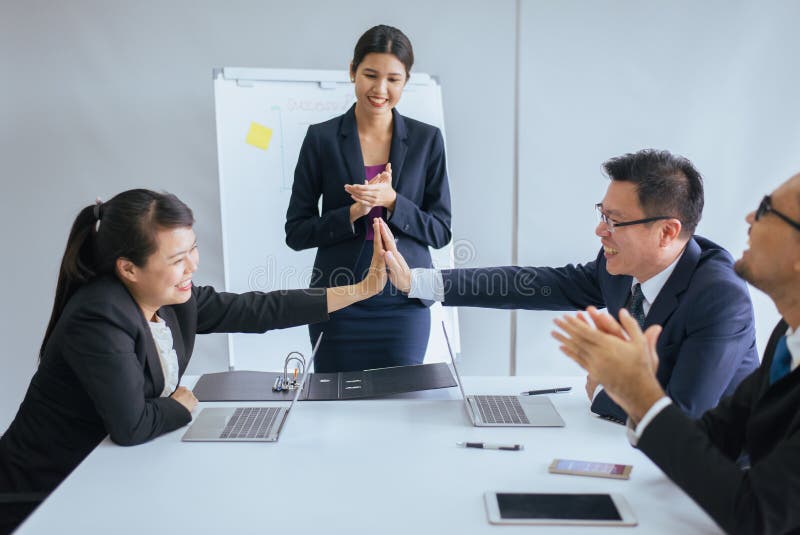 Group of business asian people hand clapping after meeting,Success presentation and coaching seminar at office. Group of business asian people hand clapping after meeting,Success presentation and coaching seminar at office