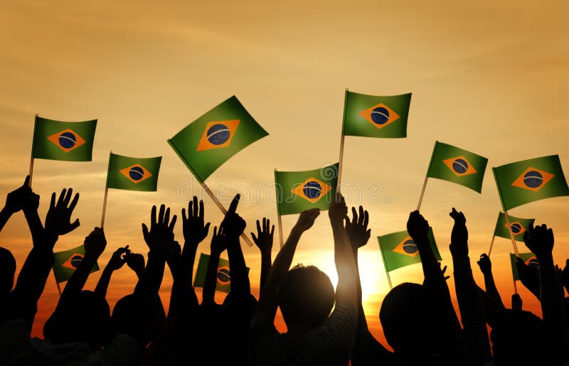 Group of People Waving Brazilian Flags in Back Lit. Group of People Waving Brazilian Flags in Back Lit.