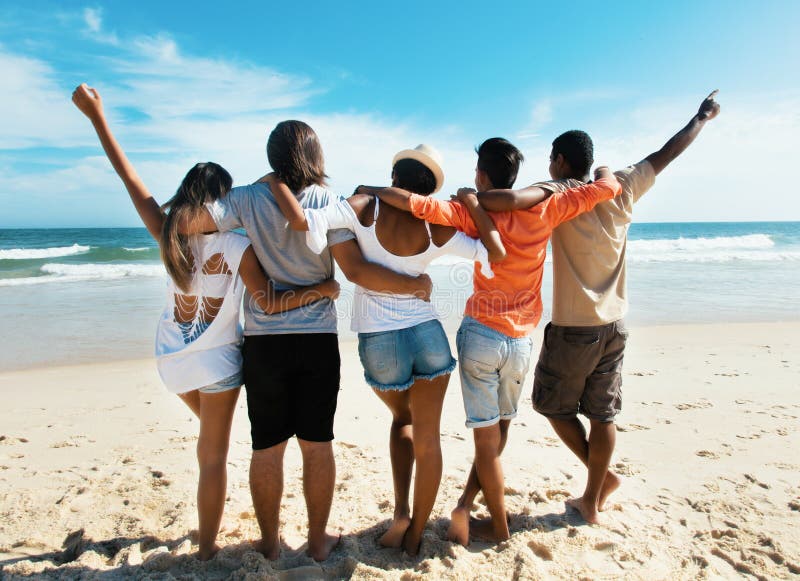Groep het toejuichen van jonge volwassenen bij strand