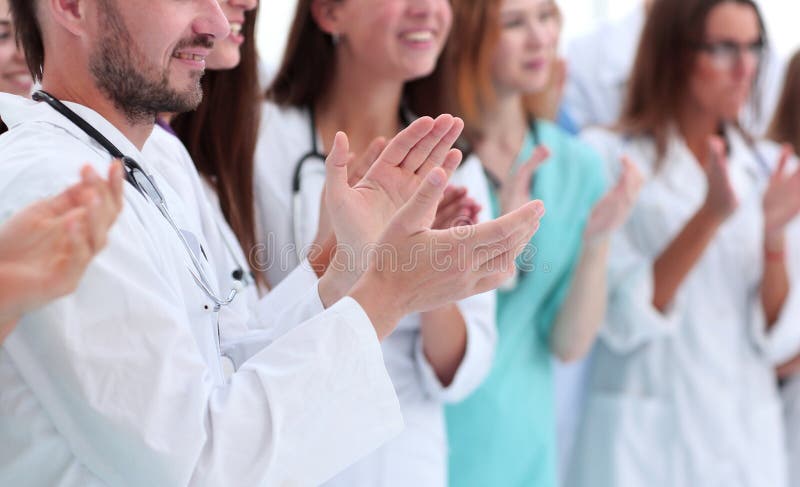 Close up. group of diverse doctors applauding their joint success. Close up. group of diverse doctors applauding their joint success.