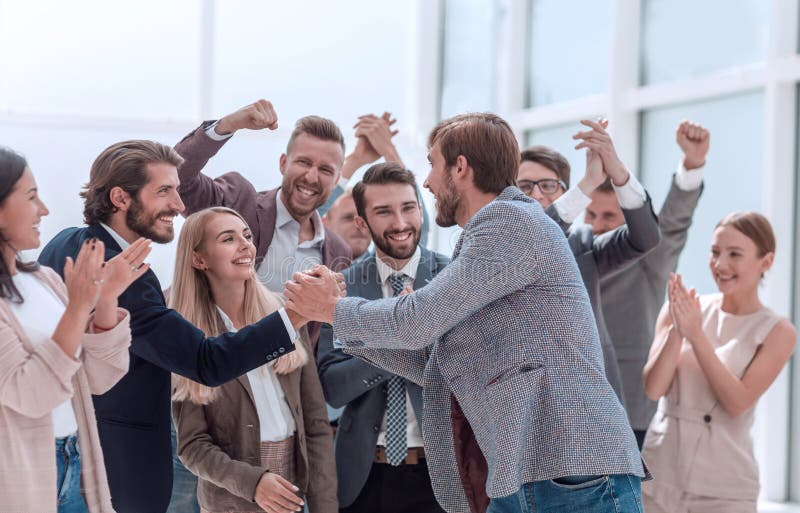 Close up. corporate group of employees congratulating their colleague. success concept. Close up. corporate group of employees congratulating their colleague. success concept