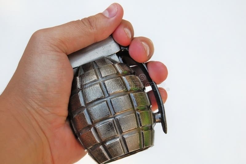 Hand holding a grenade on white background. Hand holding a grenade on white background