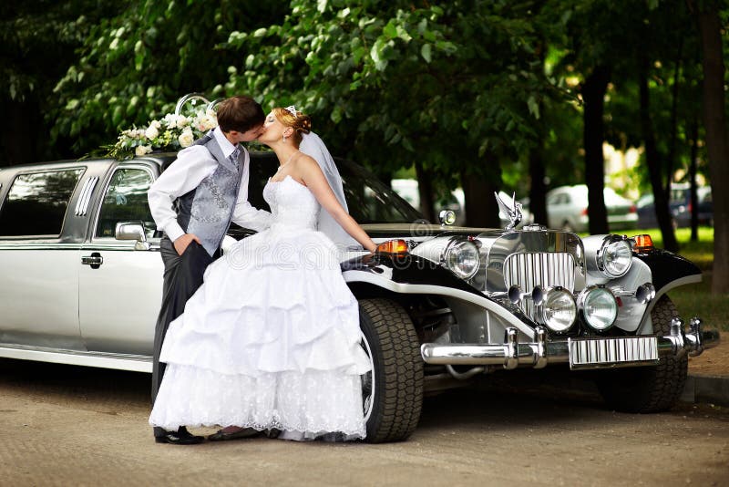 Groom adn bride about retro limousine