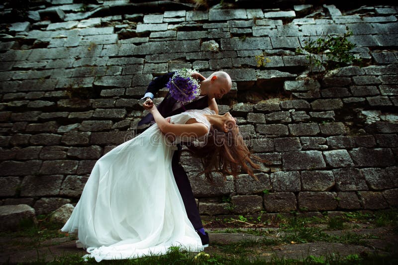 Groom bends bride over and her hair spreads around.