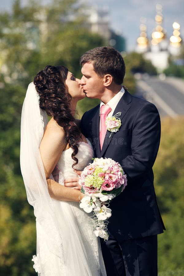 Groom and bride kissing royalty free stock photo