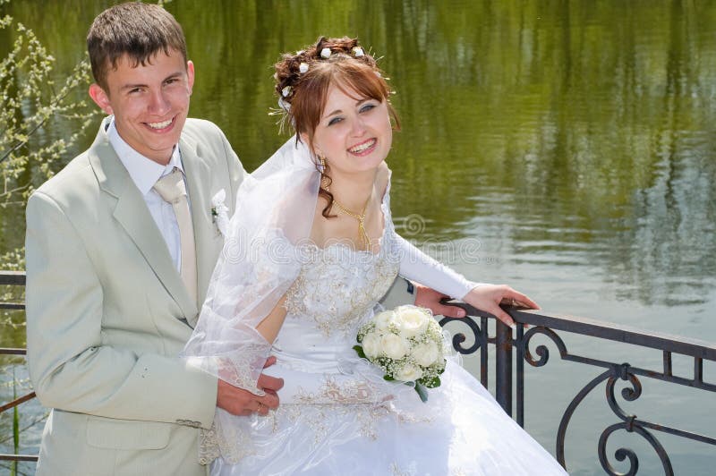 The groom and the bride on lake.