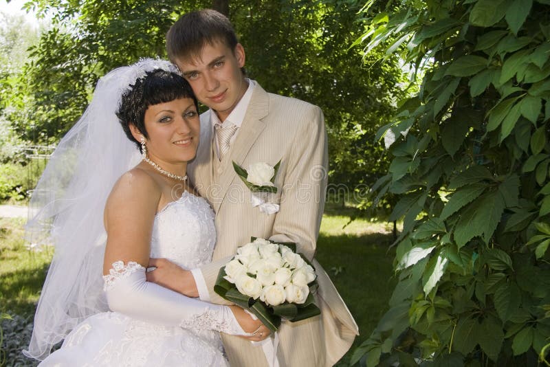 Groom and the bride on walk in park