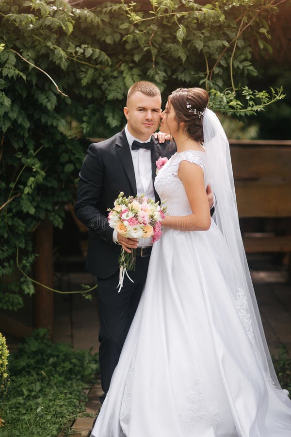 Groom and bride walk in the park on their wedding day. Happy couple spend time together royalty free stock images Groom and bride walk in the park on their wedding day. Happy couple spend time together royalty free stock images