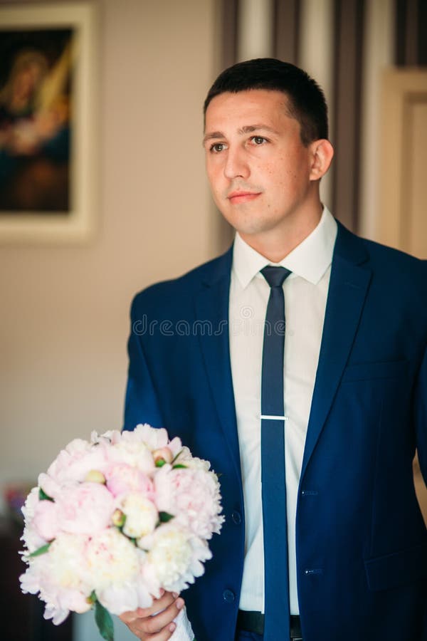 The Groom Is Dressed At Home In A Suit. Cute Groom Posing For A ...