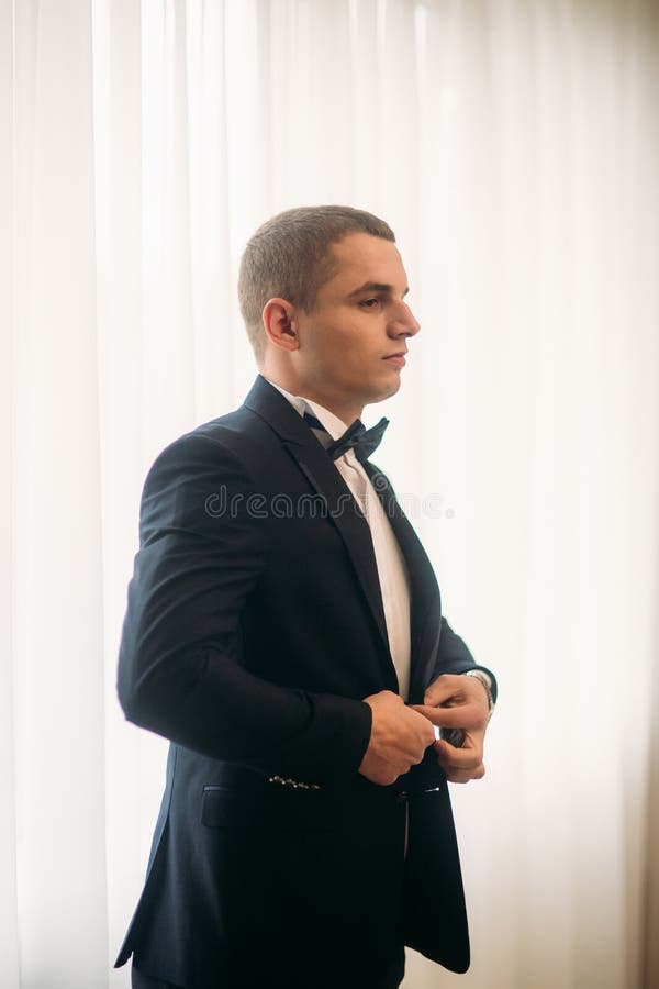 The Groom is Dressed at Home in a Suit. Cute Groom Posing for a ...
